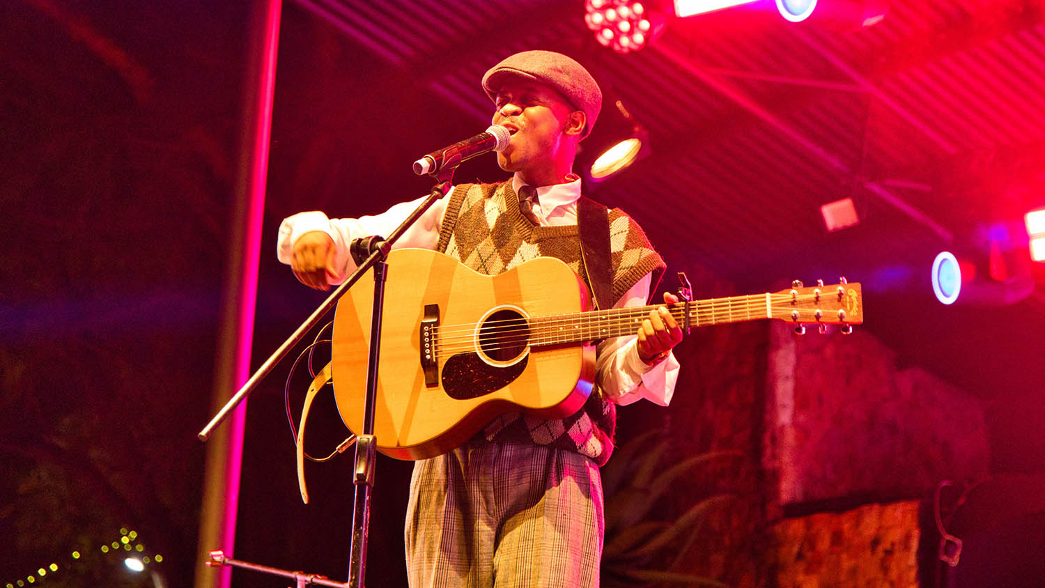 Booshle all smiles as he continues perfrming on the stage.